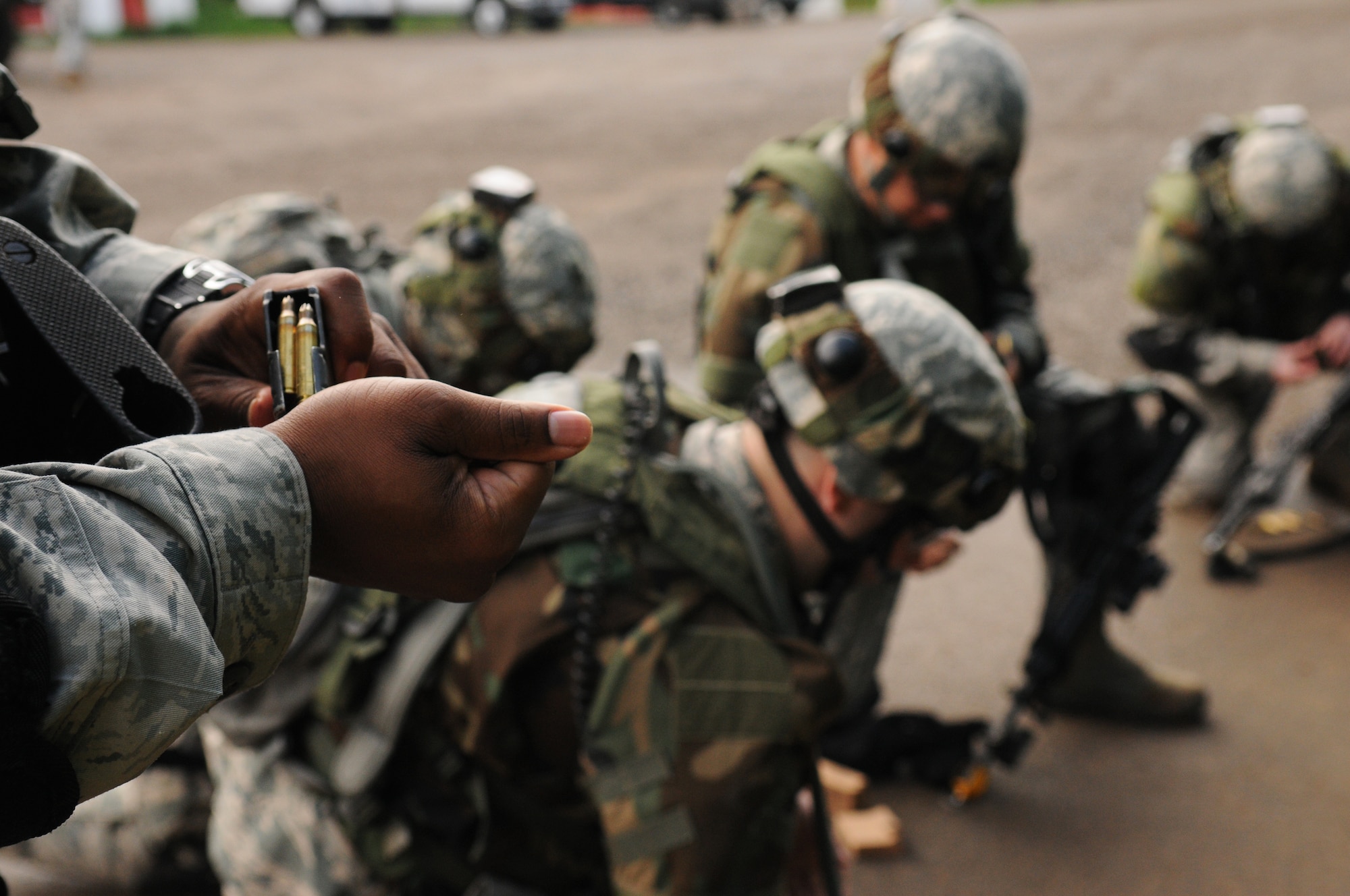 Creek Defender students load blank rounds into magazines in preparation for training, Baumholder, Germany, May 15, 2009. Students attend the Creek Defender Regional Training Center to hone and sharpen skills learned through previous training in preparation for upcoming deployments. (U.S. Air Force photo by Senior Airman Levi Riendeau)