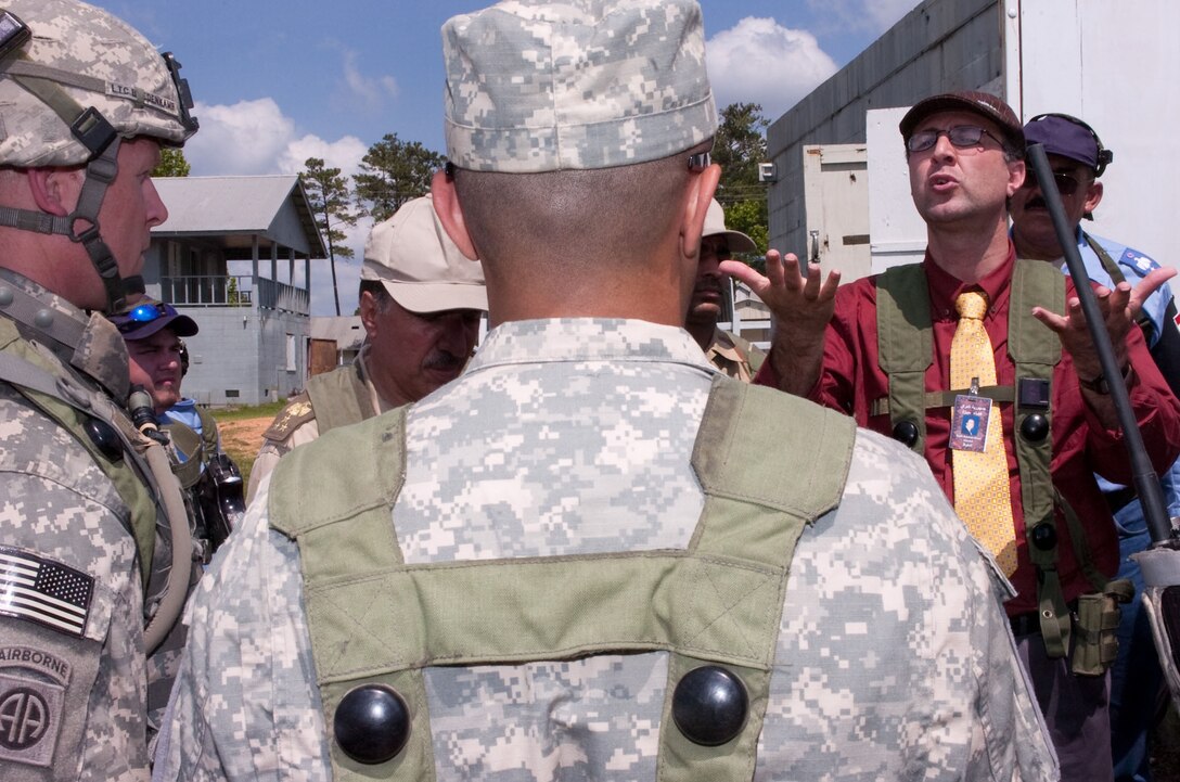 U.S. Army Lt. Col. Trevor Bredenkamp listens to a role-playing Iraqi Qadaa commissioner express frustration with local security during the opening ceremony of a new police station in the fictitious Iraqi town of Suliyah as part of the brigade’s training at the Joint Readiness Training Center, Fort Polk, La., May 15, 2009. Bredenkamp is commander, 82nd Airborne Division's 2nd Battalion, 504th Parachute Infantry Regiment, 1st Brigade Combat Team.