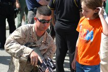 A Marine shows Patrick Bowe of Pelham N.Y, his rifle after the Marines preformed a helicopter raid in Orchard Beach, N.Y. (Official Marine Corps photo by Lance Cpl. Jad Sleiman)