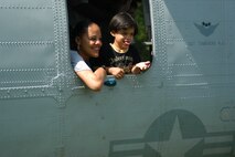 A woman and child peer out of the side window on a CH-46 Sea Knight helicopter after a helicopter raid demonstration by Special Purpose Marine Air Ground Task Force New York. (Official Marine Corps photo by Lance Cpl. Jad Sleiman)