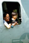 A woman and child peer out of the side window on a CH-46 Sea Knight helicopter after a helicopter raid demonstration by Special Purpose Marine Air Ground Task Force New York. (Official Marine Corps photo by Lance Cpl. Jad Sleiman)