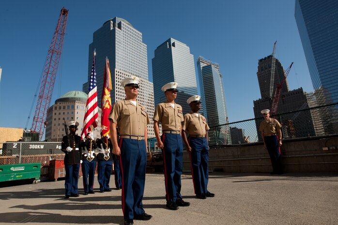 Gunnery Sgt. Justin Smith, from Cape Code, Ma., and platoon sergeant for 3rd platoon, Company C, 2nd Amphibian Assault Battalion, 2nd Marine Expeditionary Force, Staff Sgt. Deryck Smith, from Jacksonville, Fla. and substance abuse control officer for Headquarters and Support Company, 2nd Tank Battalion, 2nd MEF, and Staff Sgt. Jonathan Novak, from Villa Park, Ill., and section leader for 3rd platoon, Co. C, 2nd AA Bn., 2nd MEF, stand waiting to reenlist at the construction site of the Freedom Town in lower Manhattan, May 22. The Marines requested, and waited, to conduct the ceremony at the site of what was the World Trade Center. This event was just one of many the Special Purpose Marine Air Ground Task Force - New York will participate in during Fleet Week. (Official Marine Corps photo by: Cpl. Patrick Fleischman)