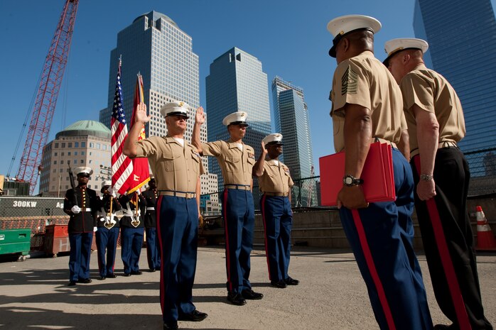 Gunnery Sgt. Justin Smith, from Cape Code, Ma., and platoon sergeant for 3rd platoon, Company C, 2nd Amphibian Assault Battalion, 2nd Marine Expeditionary Force, Staff Sgt. Deryck Smith, from Jacksonville, Fla. and substance abuse control officer for Headquarters and Support Company, 2nd Tank Battalion, 2nd MEF, and Staff Sgt. Jonathan Novak, from Villa Park, Ill., and section leader for 3rd platoon, Company C, 2nd AA Bn., 2nd MEF, reenlist at the construction site of the Freedom Town in lower Manhattan, May 22. Lt. Gen. Richard F. Natonski, commander for U.S. Marine Corps Forces Command, reenlisted the Marines during Fleet Week 2009.