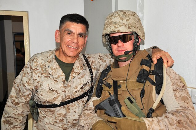 Then-Staff Sgt. Jason Eckman, the staff noncommissioned officer-in-charge of the 2nd Marine Logistics Group (Forward) personal security detail, stands with the 2nd MLG (Fwd) commanding general, Brig. Gen. Juan G. Ayala, at Camp Al Taqaddum, Iraq, May 1, 2009. Eckman was combat meritoriously promoted to gunnery sergeant during a ceremony aboard Camp Al Taqaddum May 2. (U.S. Marine Corps photograph by Sgt. Richard McCumber III)
