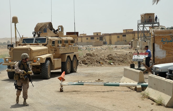 Gunnery Sgt. Jason Eckman, the staff noncommissioned officer-in-charge of the 2nd Marine Logistics Group (Forward) personal security detail, guides a vehicle during a visit to an Iraqi Police security station in Habbaniyah, Iraq, May 23, 2009. Eckman was combat-meritoriously promoted to gunnery sergeant during a ceremony aboard Camp Al Taqaddum May 2. (U.S. Marine Corps photograph by Sgt. Richard McCumber III)