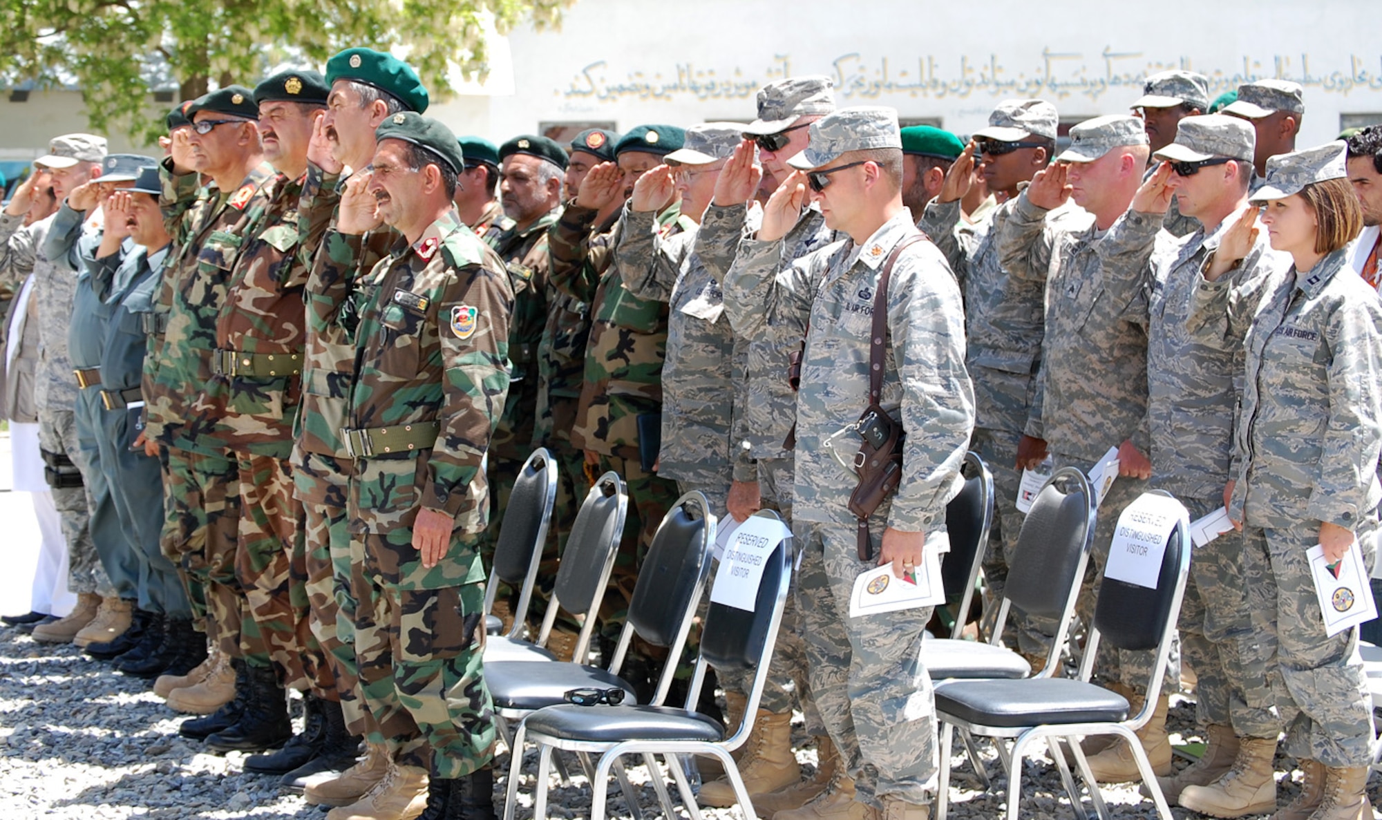 Airmen, Soldiers and Sailors embedded with the 5th Kandak (Battalion) as training advisors salute alongside their Afghan counterparts during a monument dedication May 14 outside Kabul, Afghanistan. More than 250 U.S. servicemembers and Afghan security forces celebrated seven years of military cooperation - including 18 Airmen who have provided combat support and counter-insurgency training to more than 430 Afghan soldiers within the Afghan National Army in the last year. (Air Force courtesy photo)