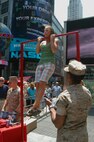 Kyla Kennedy of Plattsburgh N.Y. tries a flexed arm hang during Marine Day celebrations in Times Square May 23. (Official Marine Corps photo by Lance Cpl. Jad Sleiman)