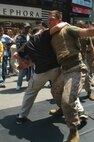 Nick  of Waterbury, Conn., takes down a Marine from Special Purpose MAGTAF New York using a leg sweek during Marine Day celebrations in Times Square May 23. (Official Marine Corps photo by Lance Cpl. Jad Sleiman)
