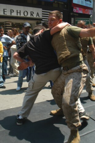 Nick  of Waterbury, Conn., takes down a Marine from Special Purpose MAGTAF New York using a leg sweek during Marine Day celebrations in Times Square May 23. (Official Marine Corps photo by Lance Cpl. Jad Sleiman)