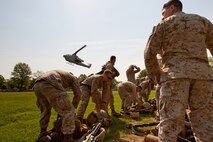 Marines from 2nd Battalion, 6th Marine Regiment with Special Purpose Marine Air Ground Task Force New York, led by 24th Marine Expeditionary Unit, take off their body armor and weapons after a simulated raid of Eisenhower Park in Long Island, N.Y., May 23. The event allowed area residents to walk through helicopters and view static displays of weapons.The 24th MEU has more than 900 Marines who are slated to showcase several events for New York's Fleet Week 2009. (Official Marine Corps photo by: Cpl. Patrick Fleischman)