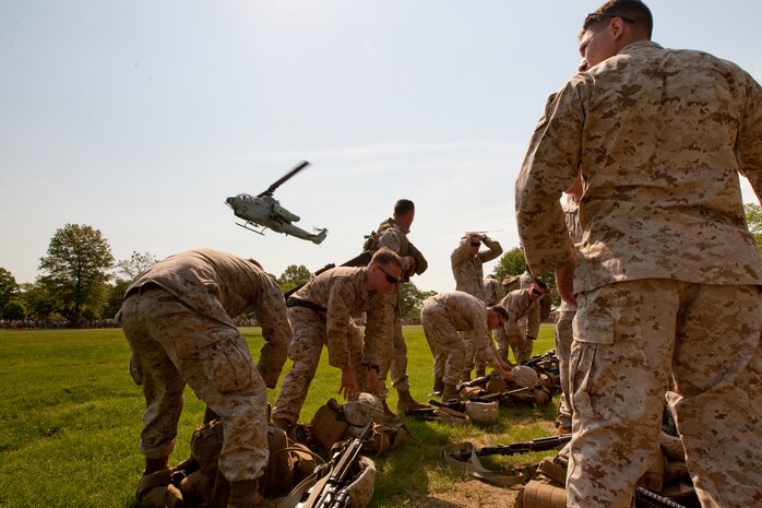 Marines from 2nd Battalion, 6th Marine Regiment with Special Purpose Marine Air Ground Task Force New York, led by 24th Marine Expeditionary Unit, take off their body armor and weapons after a simulated raid of Eisenhower Park in Long Island, N.Y., May 23. The event allowed area residents to walk through helicopters and view static displays of weapons.The 24th MEU has more than 900 Marines who are slated to showcase several events for New York's Fleet Week 2009. (Official Marine Corps photo by: Cpl. Patrick Fleischman)