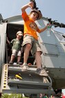A child jumps down from a CH-46E Sea Knight following a simulated raid by Marines from 2nd Battalion, 6th Marine Regiment with Special Purpose Marine Air Ground Task Force New York, led by 24th Marine Expeditionary Unit, in Eisenhower Park in Long Island, N.Y.,  May 23. The event allowed area residents to walk through helicopters and view static displays of weapons. The 24th MEU has more than 900 Marines who are slated to showcase several events for New York's Fleet Week 2009. (Official Marine Corps photo by: Cpl. Patrick Fleischman)