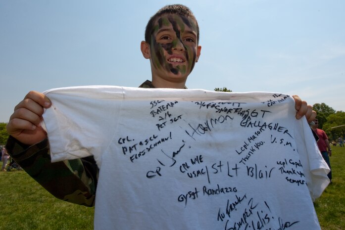 A child shows his t-shirt full of autographs of Marines from 2nd Battalion, 6th Marine Regiment with Special Purpose Marine Air Ground Task Force New York, led by 24th Marine Expeditionary Unit, in Eisenhower Park in Long Island, N.Y.,  May 23. The event allowed area residents to walk through helicopters and view static displays of weapons. The 24th MEU has more than 900 Marines who are slated to showcase several events for New York's Fleet Week 2009. (Official Marine Corps photo by: Cpl. Patrick Fleischman)