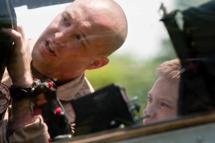 A Marines from 2nd Battalion, 6th Marine Regiment with Special Purpose Marine Air Ground Task Force New York, led by 24th Marine Expeditionary Unit, shows a child the inner workings of a AH-1W Cobra helicopter in Eisenhower Park in Long Island, N.Y.,  May 23. The event allowed area residents to walk through helicopters and view static displays of weapons. The 24th MEU has more than 900 Marines who are slated to showcase several events for New York's Fleet Week 2009. (Official Marine Corps photo by: Cpl. Patrick Fleischman)
