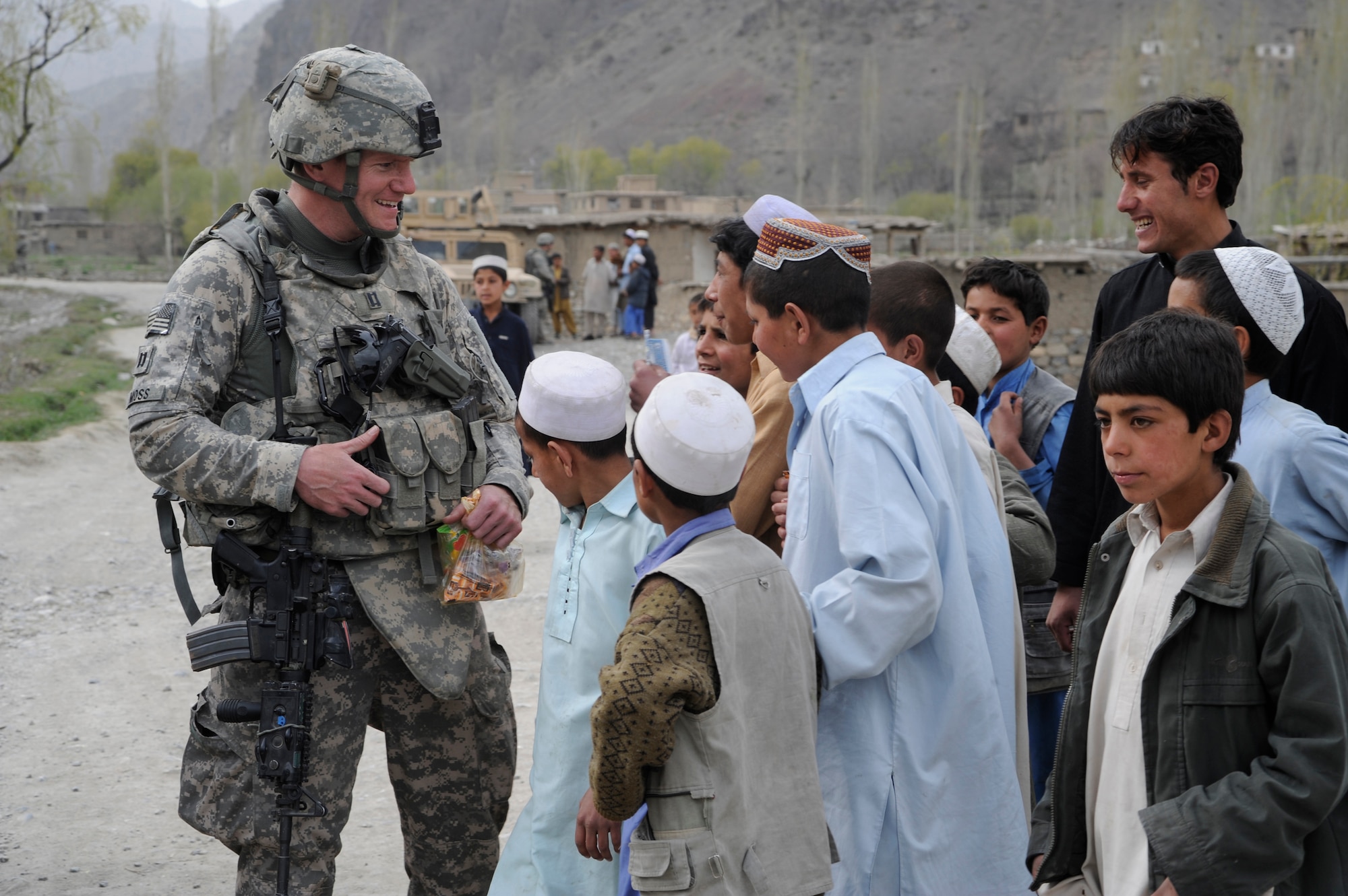 U.S. Air Force Capt. Don Moss, Chief of Intelligence, Paktya Provincial Reconstruction Team, speaks to Afghani children in a village near Forward Operating Base Herrara, Afghanistan, April 17, 2009. (U.S. Air Force photo by Staff Sgt. Shawn Weismiller)
