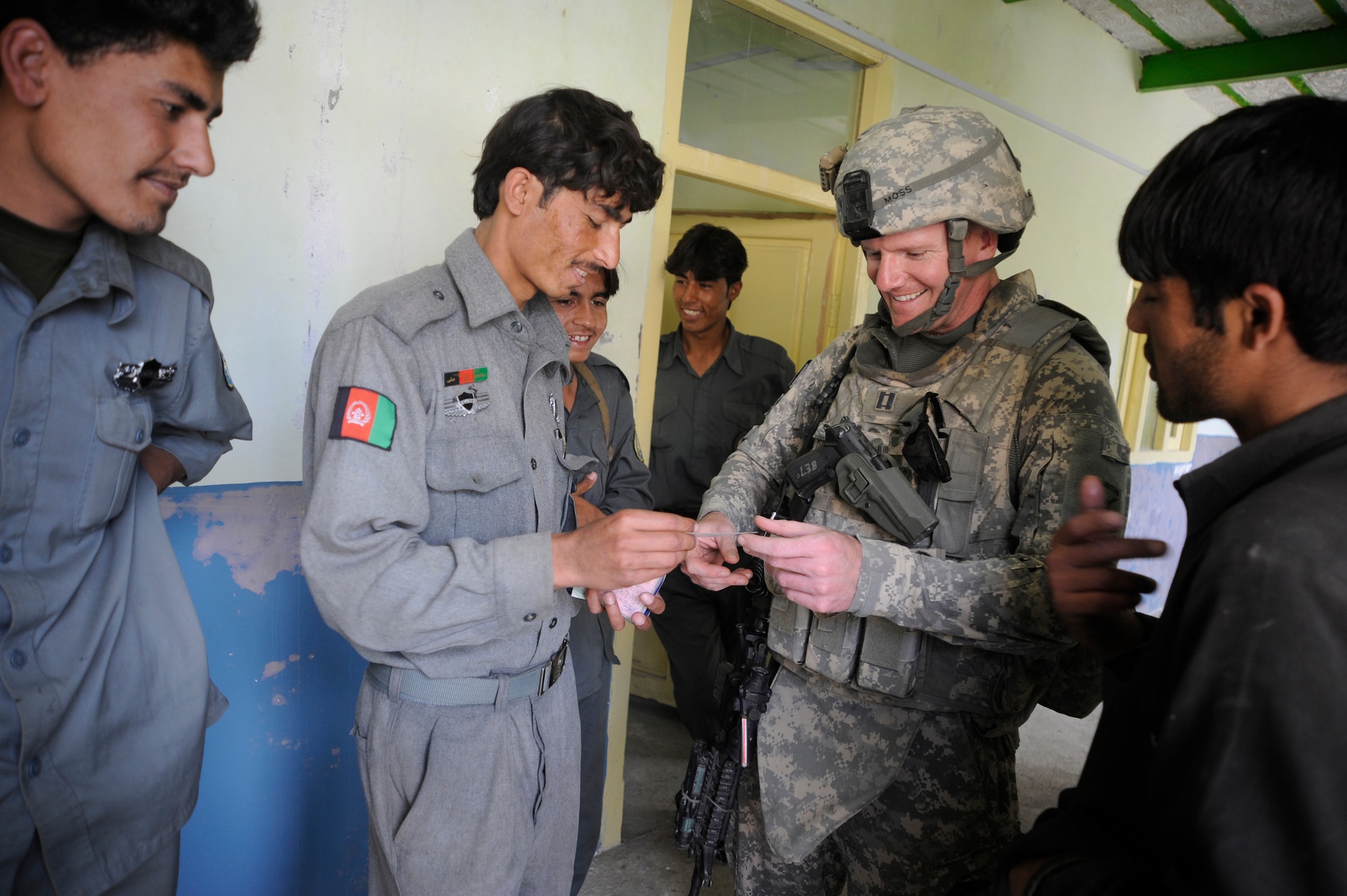 U.S. Air Force Capt. Don Moss, Chief of Intelligence, Paktya Provincial Reconstruction Team, speaks to Afghanistan National Policemen in a village near Forward Operating Base Herrara, Afghanistan, April 17, 2009. (U.S. Air Force photo by Staff Sgt. Shawn Weismiller)