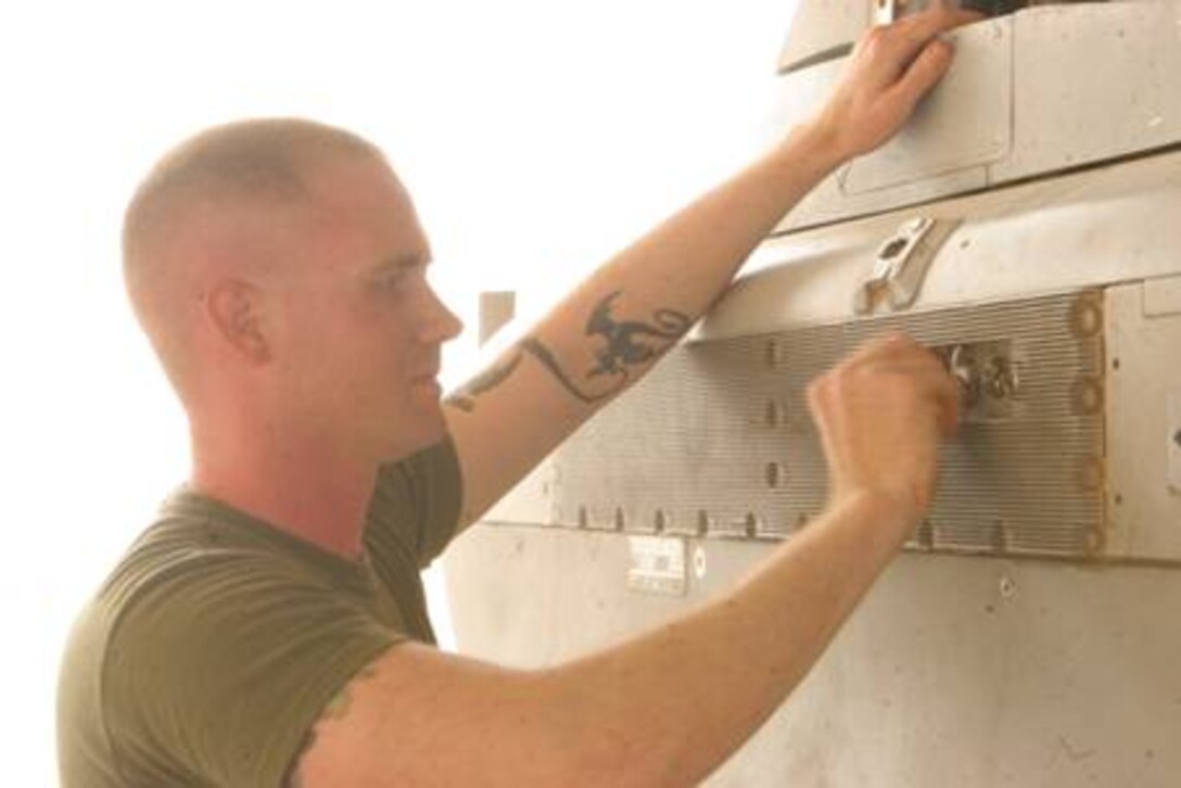 Staff Sgt. Brian Naylor, quality assurance chief with Marine Tactical Electronic Warfare Squadron 4, inspects one of the rear panels of a Prowler after its return from a mission.  This is the second deployment in support of Operation Iraqi Freedom for the Seahawks of VMAQ-4.