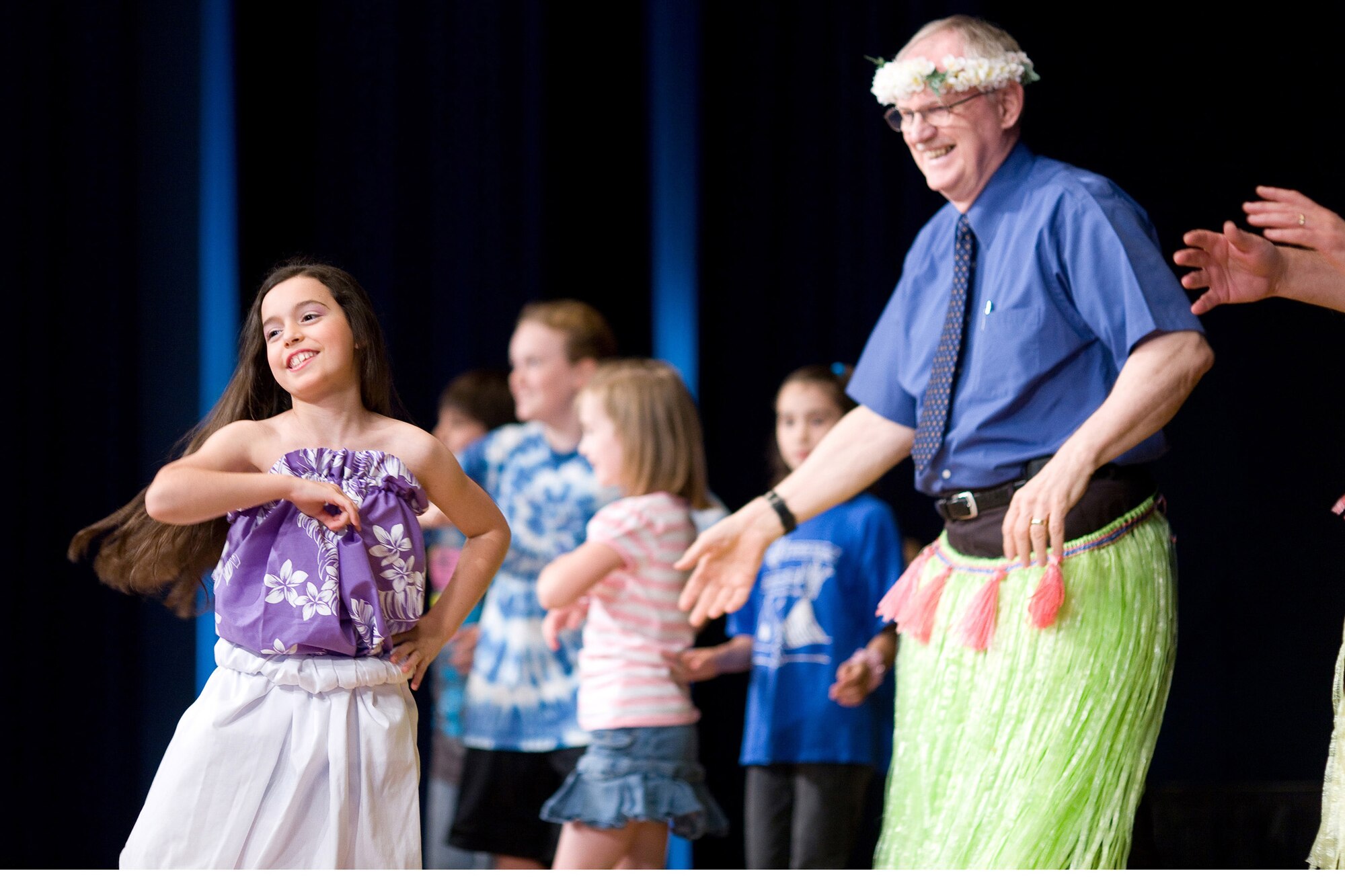 YOKOTA AIR BASE, Japan -- Veronica Quezada, a 5th grader at Yokota West Elementary School, leads fellow students and faculty members in an Hawaiian dance May 21 at the school's Asian Pacific American Heritage Celebration. The celebration also included music and dance performances from a variety of Asian Pacific cultures. (U.S. Air Force photo/Osakabe Yasuo)