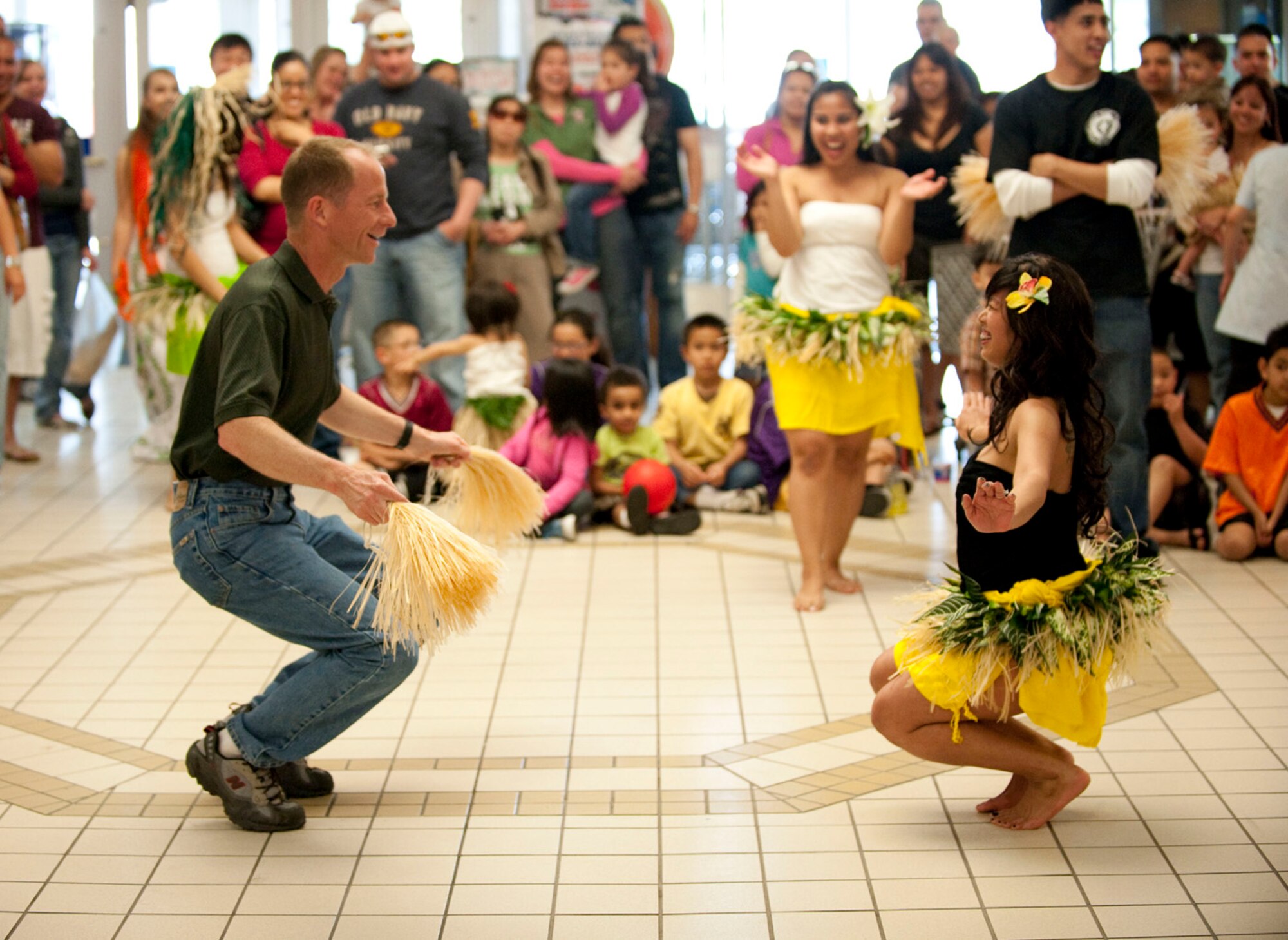 MISAWA AIR BASE, Japan -- Col. David Stilwell, 35th Fighter Wing commander, dances with a hula dancer at the Misawa Base Exchange May 16, 2009. The dancers solicited audience members to try hula dancing for themselves. (U.S. Air Force photo by Staff Sgt. Samuel Morse)