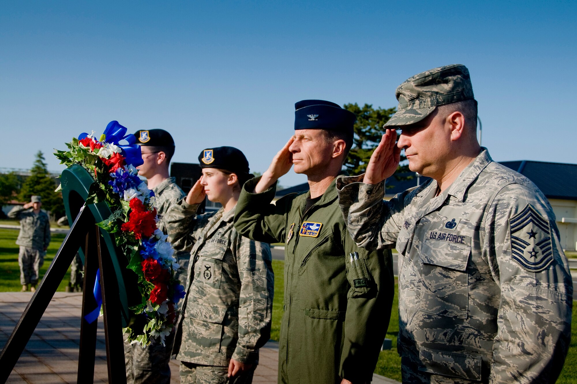 MISAWA AIR BASE, Japan -- Col. David Stilwell, 35th Fighter Wing commander, and Chief Master Sgt. Ricky Price, 35th FW command chief master sergeant, along with Airmen Basic Jarrod Chambers and Summer Robbins, 35th Security Forces Squadron, take part in a retreat ceremony to wrap up National Police Week May 15, 2009. National Police Week is designated to honor our nation's law enforcement officers and armed forces' fallen defenders. (U.S. Air Force photo by Senior Airman Jamal D. Sutter)