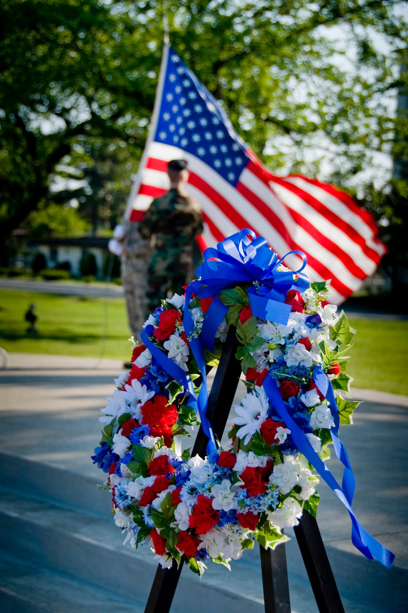 MISAWA AIR BASE, Japan -- Members of the Misawa Honor Guard retire the colors as the commemorative wreath stands during a retreat ceremony May 15, 2009. The ceremony wrapped up National Police Week, which was born from the inspiration of President John F. Kennedy, who signed a proclamation that appointed May 15 as National Peace Officers' Memorial Day and the week of May 15 as National Police Week. (U.S. Air Force photo by Senior Airman Jamal D. Sutter)