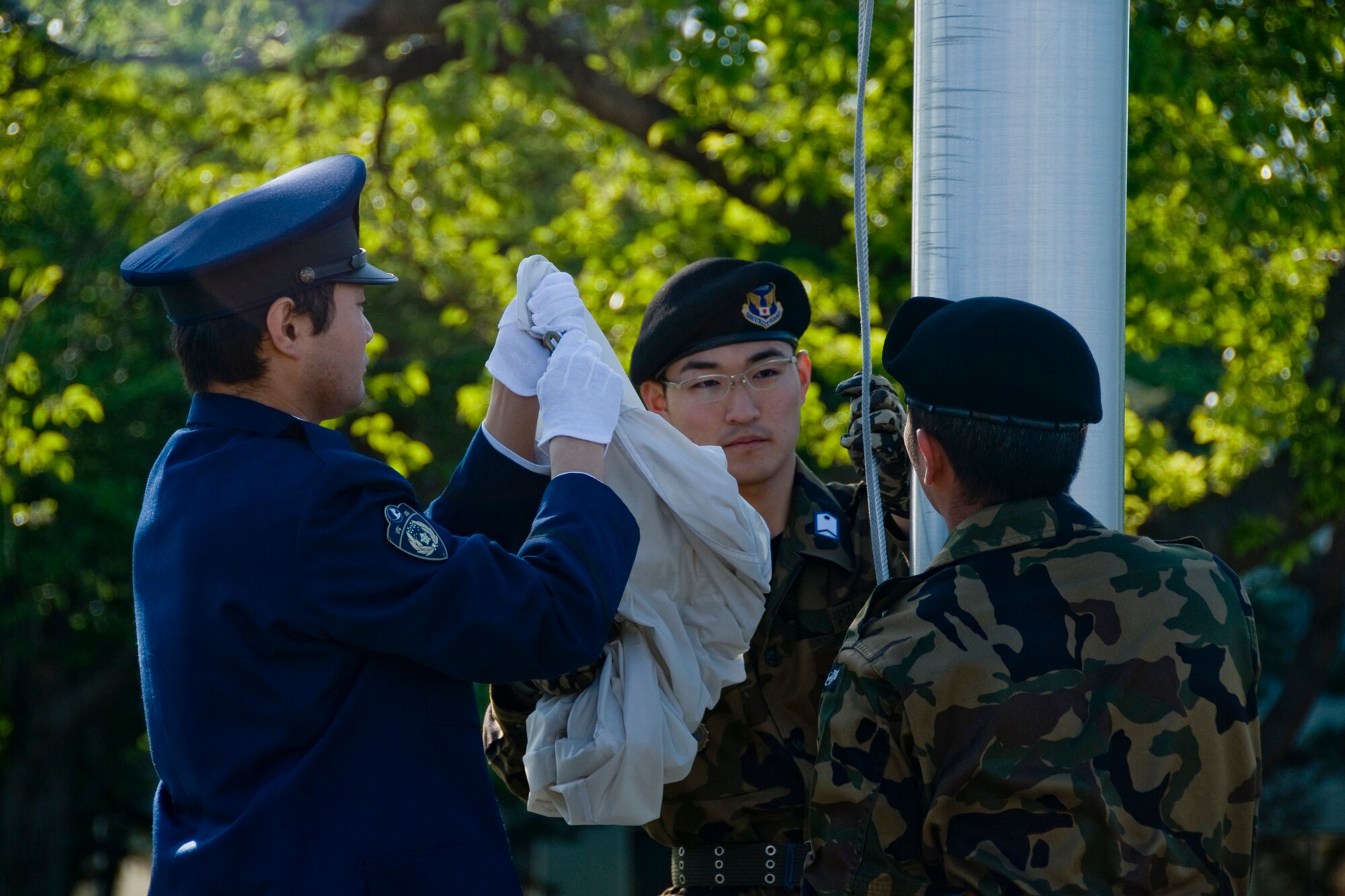 MISAWA AIR BASE, Japan -- Members of the Japan Air Self-Defense Force Honor Guard retire the Japanese flag during a retreat ceremony to wrap up National Police Week May 15, 2009. The ceremony also served as a chance to strengthen bonds amongst the various security and police agencies of the surrounding area. (U.S. Air Force photo by Senior Airman Jamal D. Sutter)
