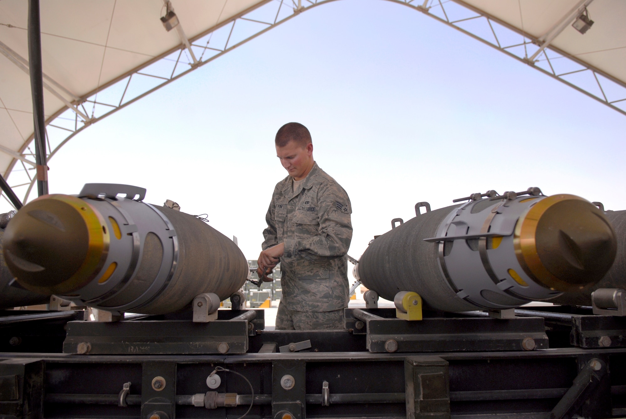 Senior Airman Richard Parvin, a 379th Expeditionary Maintenance Squadron munitions systems journeyman, attaches a KMU-572 fin kit to a GBU-38 Version 1 bomb, May 22, 2009, at an undisclosed location in Southwest Asia.  Airman Parvin is working on the tail fin section after having attached the stabilizing strakes on the nose of the bomb.  The GBU-38s are assembled and constructed by the base's munitions unit for delivery by B-1B Lancers.  Airman Parvin hails from Birmingham, Ala. and is deployed from Dyess Air Force Base, Texas, in support of Operations Iraqi and Enduring Freedom and Combined Joint Task Force - Horn of Africa.  (U.S. Air Force photo/Senior Airman Andrew Satran/released)