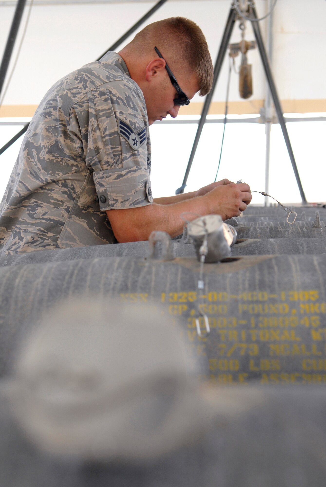 Senior Airman Timothy Bradford, a 379th Expeditionary Maintenance Squadron munitions systems journeyman, applies RTV lubricant onto an FZU-55 bomb fuze initiator for a GBU-38 Version 1 bomb, May 22, 2009 at an undisclosed location in Southwest Asia.  The GBU-38s are assembled and constructed by the base's munitions unit for delivery by B-1B Lancers.  Airman Bradford hails from Burleson, Texas and is deployed from Dyess Air Force Base, Texas in support of Operations Iraqi and Enduring Freedom and Combined Joint Task Force - Horn of Africa.  (U.S. Air Force photo/Senior Airman Andrew Satran/released)