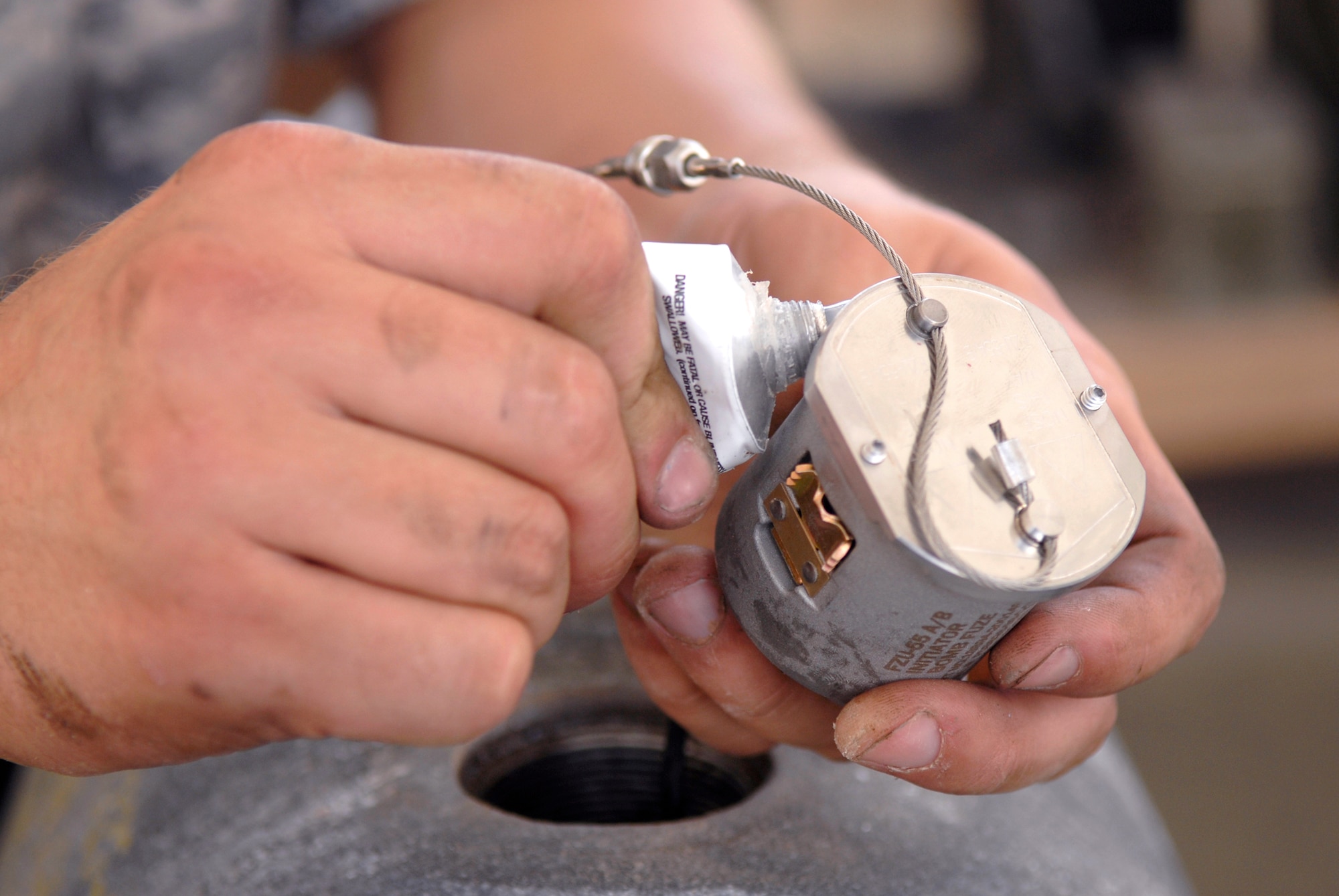 Senior Airman Timothy Bradford, a 379th Expeditionary Maintenance Squadron munitions systems journeyman, applies RTV lubricant onto an FZU-55 bomb fuze initiator for a GBU-38 Version 1 bomb, May 22, 2009, at an undisclosed location in Southwest Asia.  The FZU-55 is an air actuated generator which provides power for the fuze in the bomb.  The GBU-38s are assembled and constructed by the base's munitions unit for delivery by B-1B Lancers.  Airman Bradford hails from Burleson, Texas and is deployed from Dyess Air Force Base, Texas in support of Operations Iraqi and Enduring Freedom and Combined Joint Task Force - Horn of Africa.  (U.S. Air Force photo/Senior Airman Andrew Satran/released)