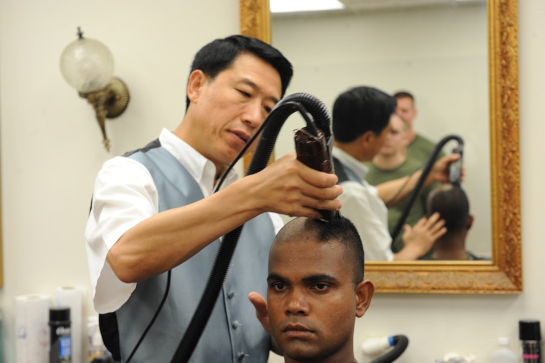 Candidates from Golf Company, Officer Candidate School, are given thier initial haircut prior to the start of their training aboard Marine Corps Base Quantico, Va., Monday, May 25, 2009. The candidates face 10-weeks of demanding training to screen and evaluate their leadership skills and determine whether they can efficiantly lead Marines. (U.S. Marine Corps photo by LCpl John Kennicutt/Not Released)