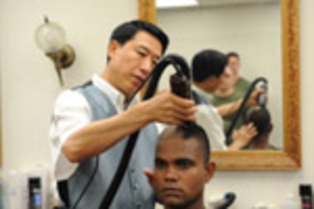 Candidates from Golf Company, Officer Candidate School, are given thier initial haircut prior to the start of their training aboard Marine Corps Base Quantico, Va., Monday, May 25, 2009. The candidates face 10-weeks of demanding training to screen and evaluate their leadership skills and determine whether they can efficiantly lead Marines. (U.S. Marine Corps photo by LCpl John Kennicutt/Not Released)