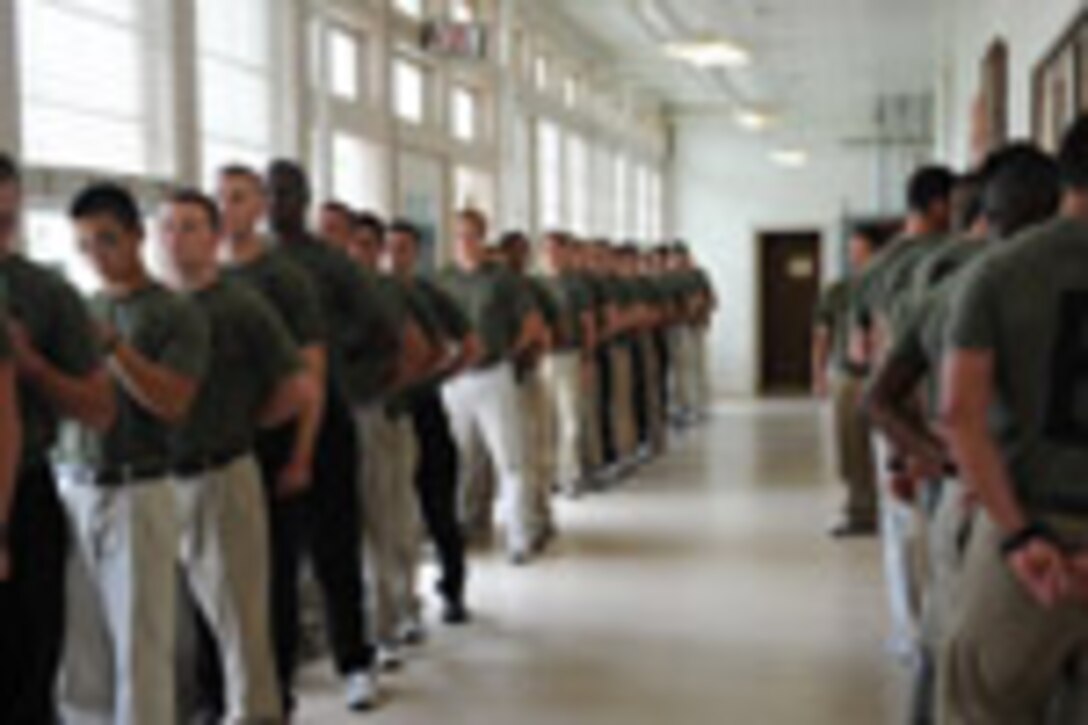 Candidates from Echo Company, Officer Candidate School, receive their initial haircuts aboard Marine Corps Base Quantico, Va., May 25, 2009.