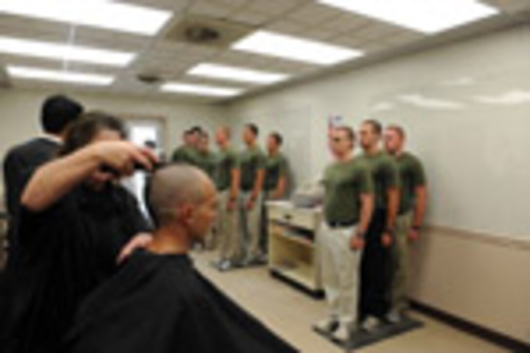 Candidates from Echo Company, Officer Candidate School, receive their initial haircuts aboard Marine Corps Base Quantico, Va., May 25, 2009.