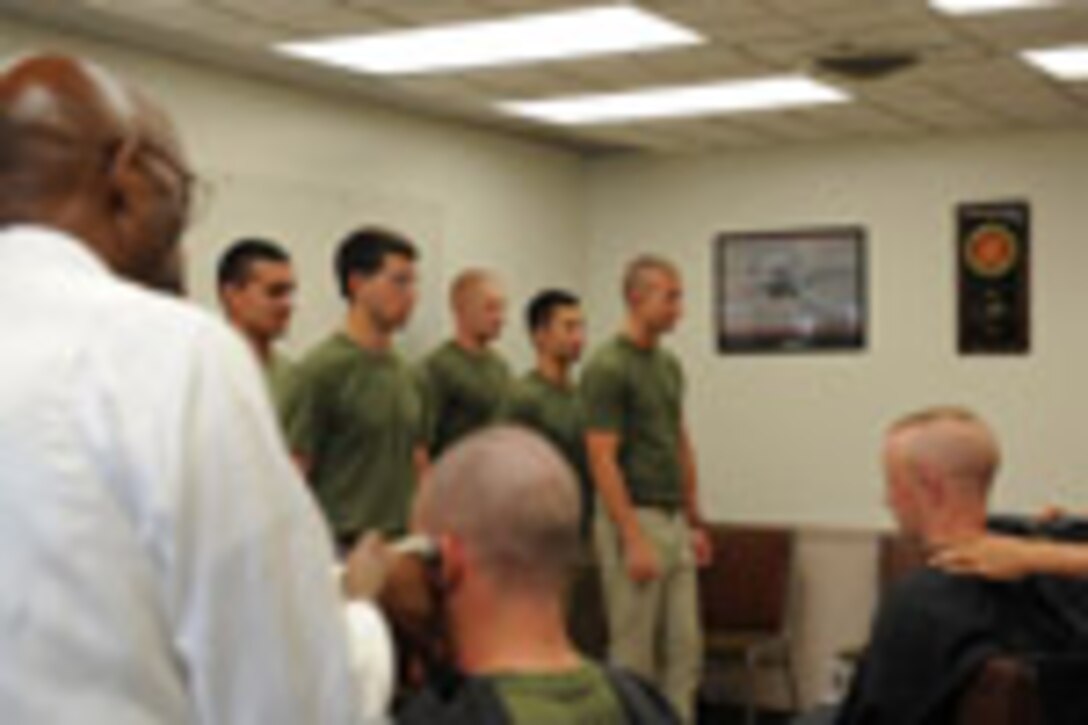 Candidates from Echo Company, Officer Candidate School, receive their initial haircuts aboard Marine Corps Base Quantico, Va., May 25, 2009.