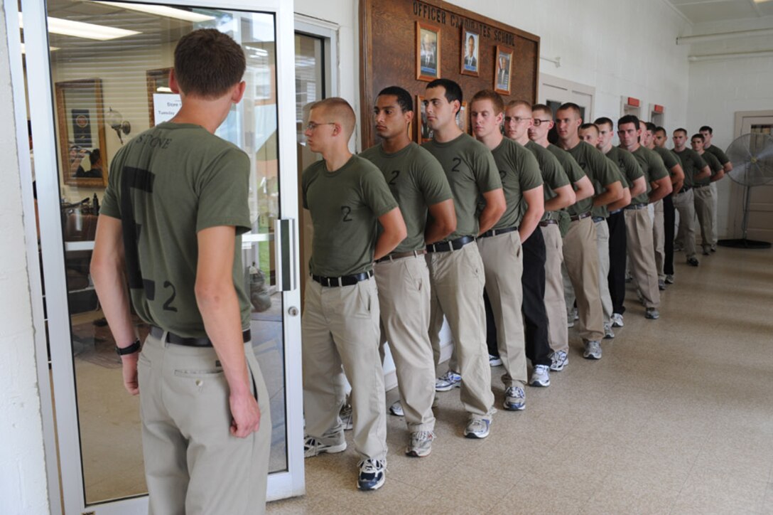 Candidates from Echo Company, Officer Candidate School, receive their initial haircuts aboard Marine Corps Base Quantico, Va., May 25, 2009.