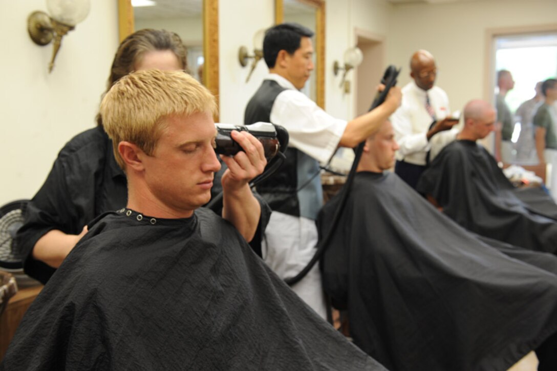 Candidates from Echo Company, Officer Candidate School, receive their initial haircuts aboard Marine Corps Base Quantico, Va., May 25, 2009.
