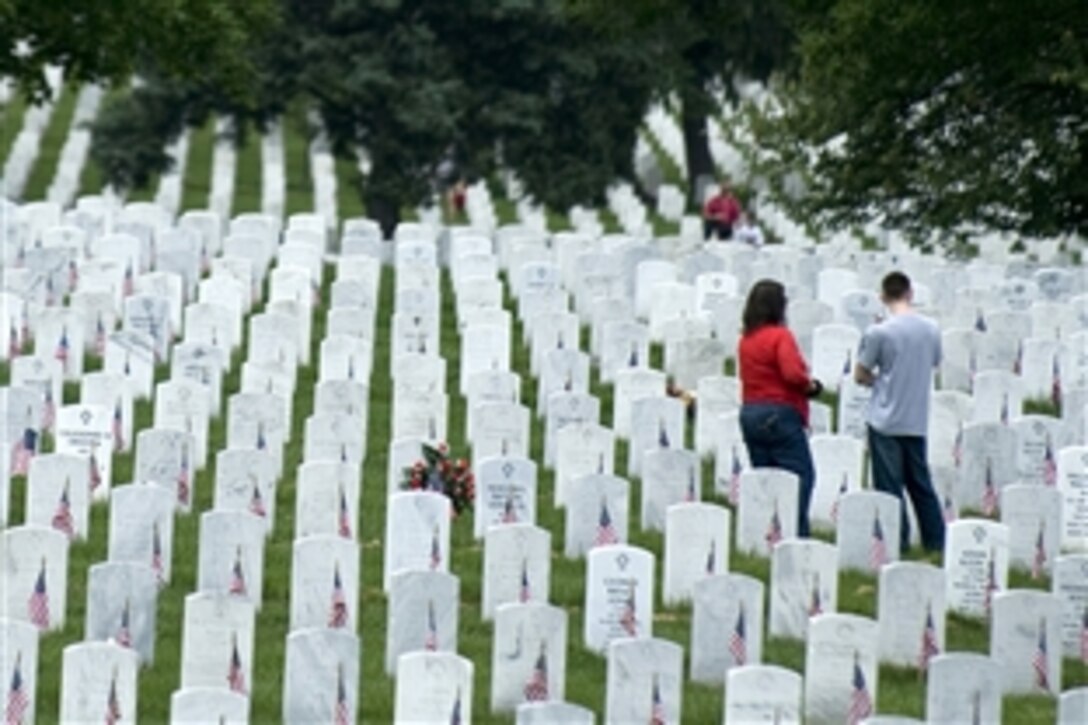 Family members visit the gravesite of a loved one during Memorial Day at Arlington National Cemetery, Arlington, Va., May 25, 2009. 