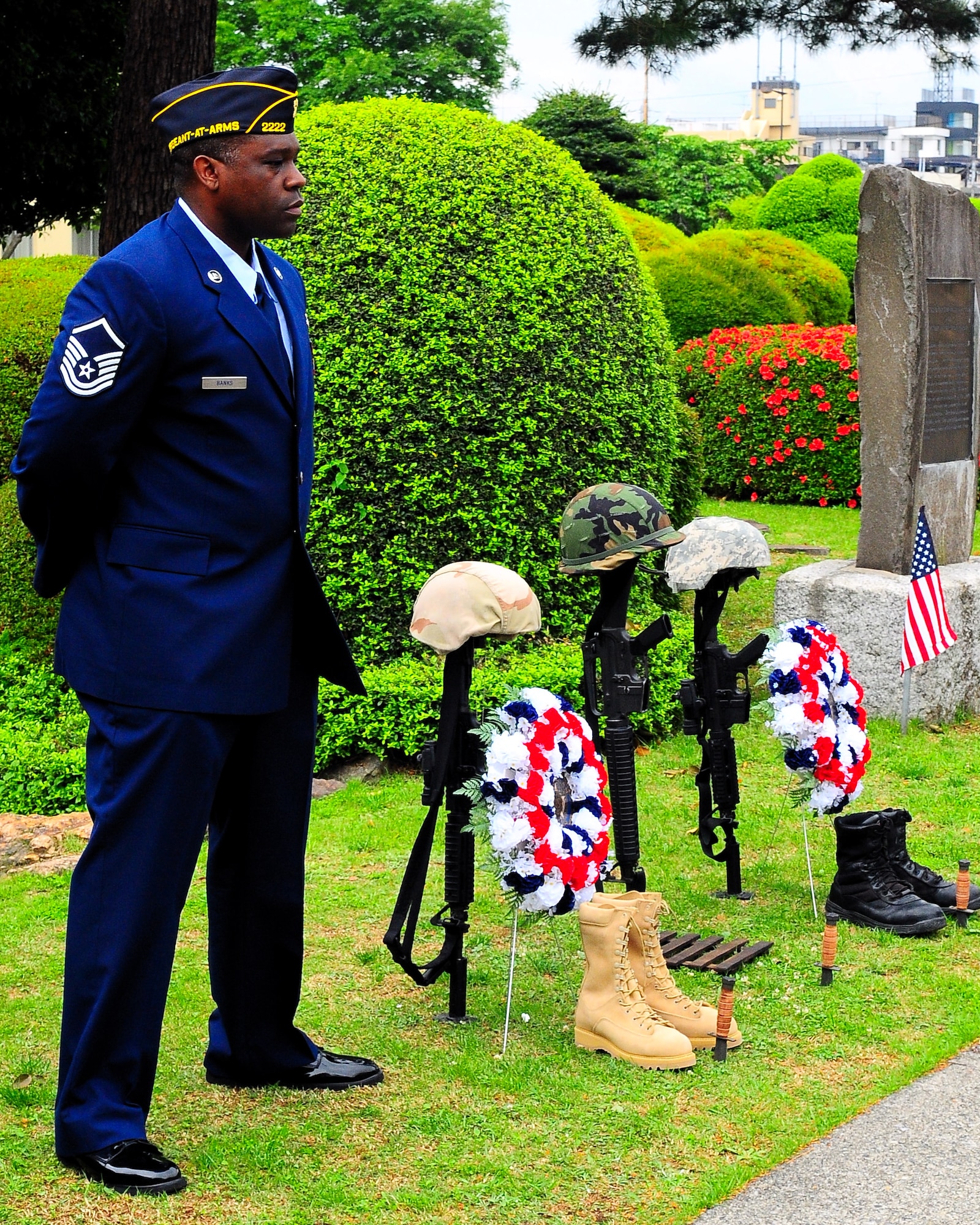 YOKOTA AIR BASE, Japan -- Master Sgt. Sean Banks of American Legion Post 2222 stands vigil over a Fallen Soldiers Memorial May 25 during a Memorial Day service at the officers' club memorial garden. The post conducts the annual service to carry on a tradition which began May 30, 1868, when flowers were placed on the graves of Union and Confederate soldiers at Arlington National Cemetery. (U.S. Air Force photo/Airman 1st Class Michael Dillon)