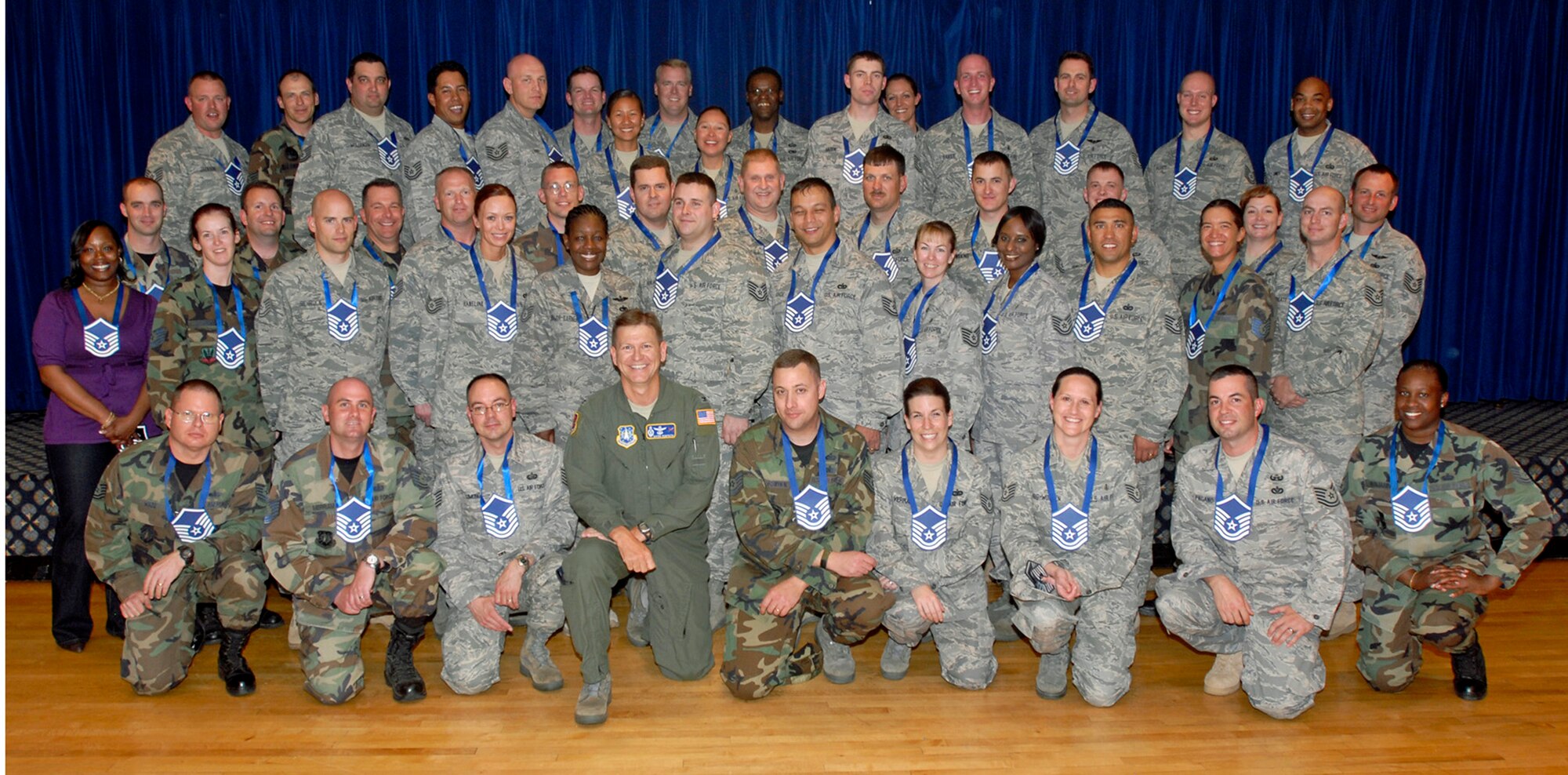 Col. Wayne Monteith, 21st Space Wing vice commander (first row, middle), poses with most of Peterson's master-sergeant-selects at the master-sergeant-select party held at the Peterson Club May 14. Approximately 80 technical sergeants assigned to Peterson and its geographically seperated units will be promoted to master sergeant within the next year. Air Force officials selected 5,604 of 22,748 eligibile technical sergeants for promotion. (Air Force photo by Larry Hulst) 