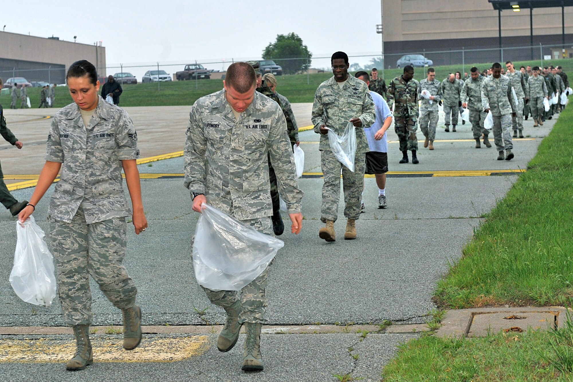 OFFUTT AIR FORCE BASE, Neb.,-- Members of Team Offutt search for foreign objects and debris during a FOD  walk here May 26. By removing foregin objects and debris Team Offutt members helped ensure the safety of Offutt's aircraft and personnel. U.S. Air Force photo by Charles Haymond 