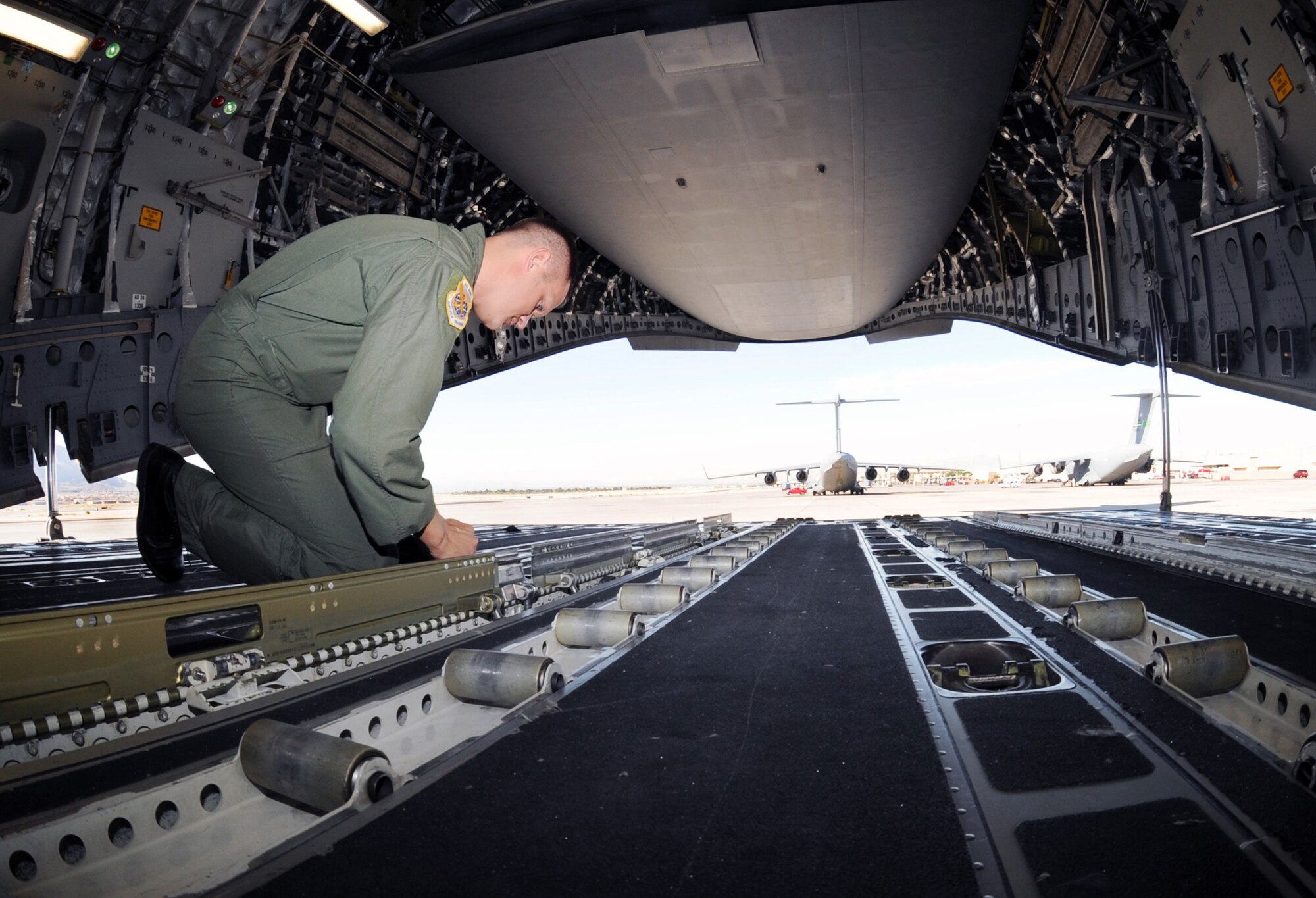 Tech. Sgt. Joshua Hoogstra performs a preflight inspection on a C-17 Globemaster III during the Mobility Air Forces Exercise May 20 at Nellis Air Force Base, Nev.  He is a loadmaster assigned to Headquarters Air Mobility Command at Scott Air Force Base, Ill. (U.S. Air Force Photo/Senior Airman Brian Ybarbo, released)