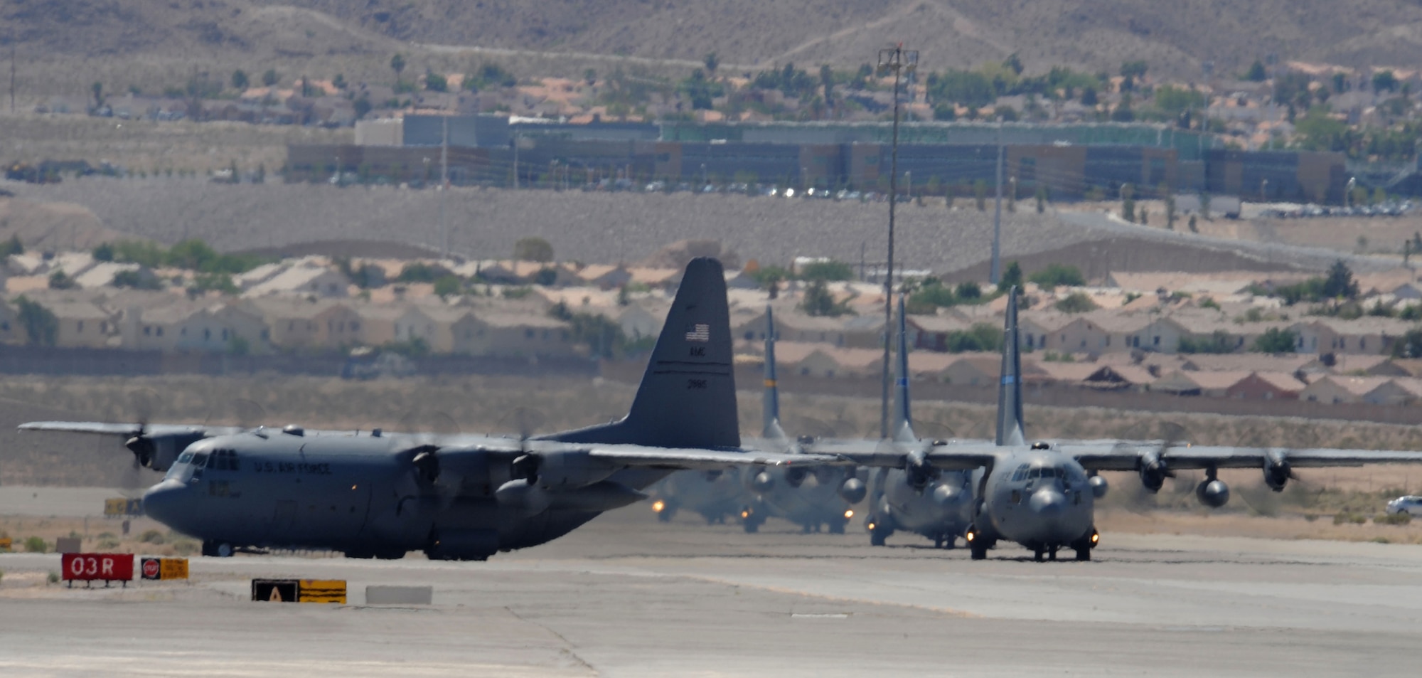 Several C-130 Hercules prepare for takeoff May 20 at Nellis Air Force Base, Nev., while participating in the Mobility Air Forces Exercise.  Approximately 12 U.S. Air Force bases participate in the MAFEX at the U.S. Air Force Weapons School twice a year, testing the crew ability of C-17 Globemaster IIIs and C-130s to join together in formation at a specific time and location to drop a brigade-size force anywhere in the world.  (U.S. Air Force photo/Senior Airman Nadine Y. Barclay)
