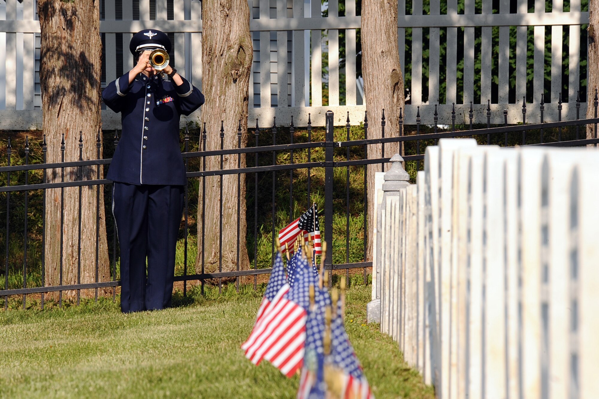 OFFUTT AIR FORCE BASE, Neb. - Tech. Sgt. Jennifer Bales, Heartland of America Band, plays "Taps" during the Memorial Day service at the Offutt Cemetery May 25.  The ceremony honors the men and women who've served and continue to serve in the United States military.U.S. Air Force Photo by Josh Plueger