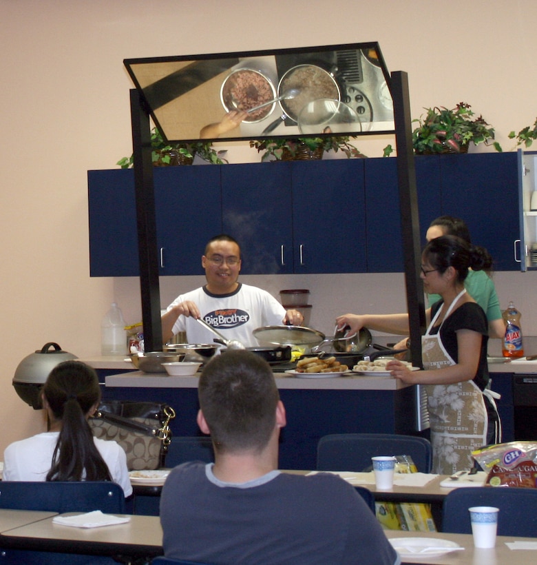 First Lieutenant Theresa Philpot and Senior Airman Christopher Francisco teach a class on Filipino cooking at the Vance Health and Wellness Center as part of Asian Pacific American Heritage Month May 14. (courtesy photo)
