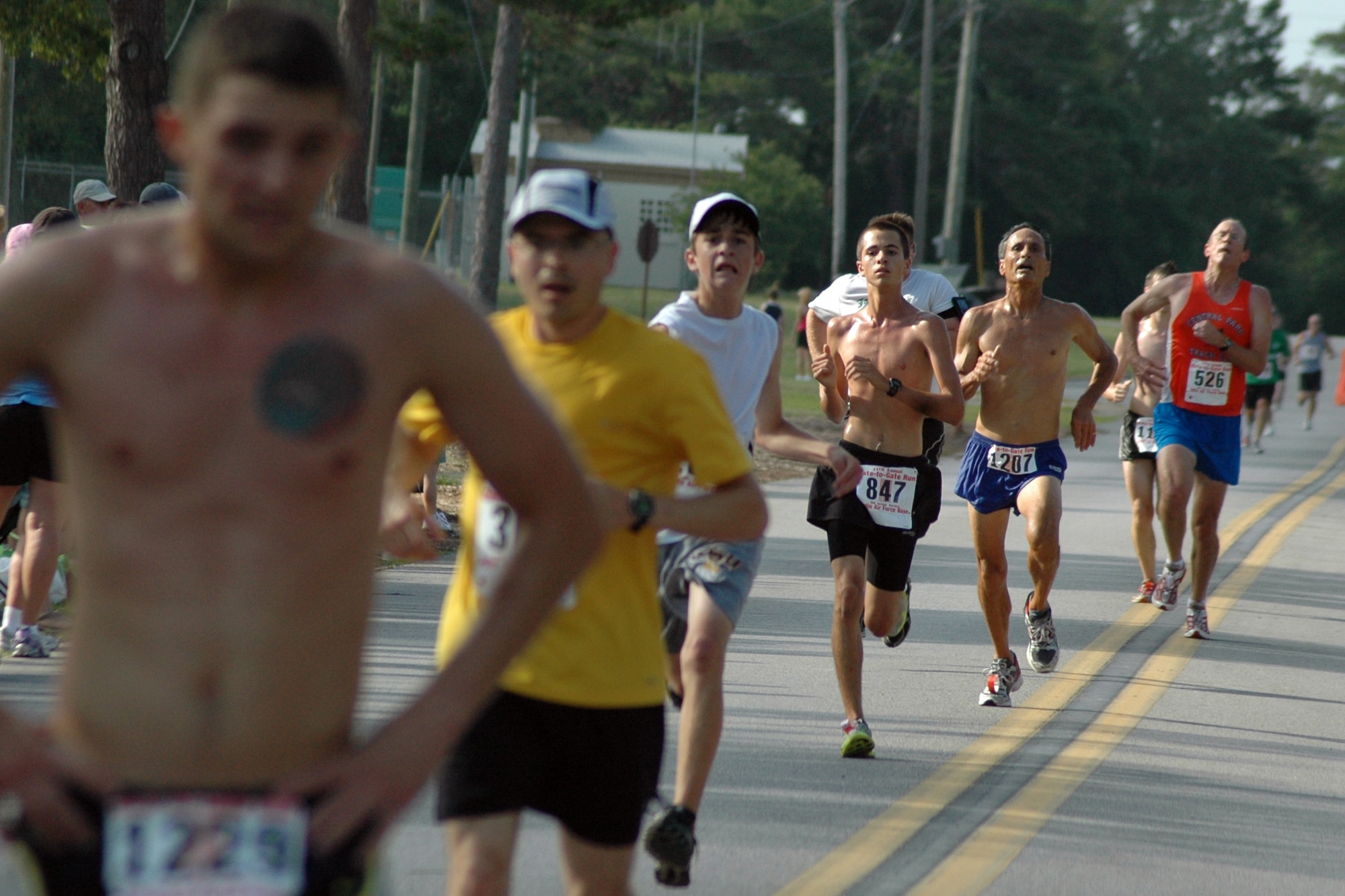 EGLIN AIR FORCE BASE, Fla. – Athletes sprint down the final stretch of the 4.4 mile run during the 24th Annual Gate-to-Gate Run May 25, here. The event is an Eglin tradition dating back to 1985, when now retired Lt. Gen. Gordon Fornell, former Armament Division commander here, proposed a run as a way to keep Airmen on base for Memorial Day due to the rise in injuries and fatalities involving Airmen. Traditionally, the run went from gate to gate but was recently modified for safety reasons. More than 1,950 runners participated in the event ranging from ages eight to 87. Matthew Martin, 26, from Hoover, Ala., was the first to finish with a time of 23:34. 2nd Lt. Ilea Eskildsen, 23, was the first female to finish with a time of 27:24. (U.S. Air Force photo/ Airman Anthony Jennings)