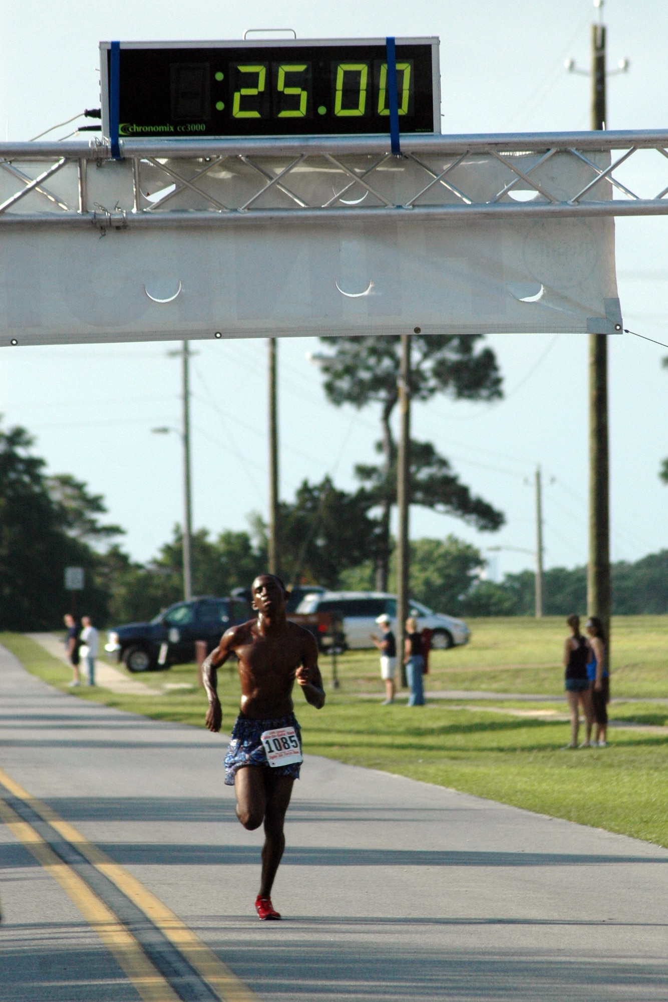 EGLIN AIR FORCE BASE, Fla. – An athlete sprints down the final stretch of the 4.4 mile run during the 24th Annual Gate-to-Gate Run May 25, here. The event is an Eglin tradition dating back to 1985, when now retired Lt. Gen. Gordon Fornell, former Armament Division commander here, proposed a run as a way to keep Airmen on base for Memorial Day due to the rise in injuries and fatalities involving Airmen. Traditionally, the run went from gate to gate but was recently modified for safety reasons. More than 1,950 runners participated in the event ranging from ages eight to 87. Matthew Martin, 26, from Hoover, Ala., was the first to finish with a time of 23:34. 2nd Lt. Ilea Eskildsen, 23, was the first female to finish with a time of 27:24. (U.S. Air Force photo/ Airman Anthony Jennings)