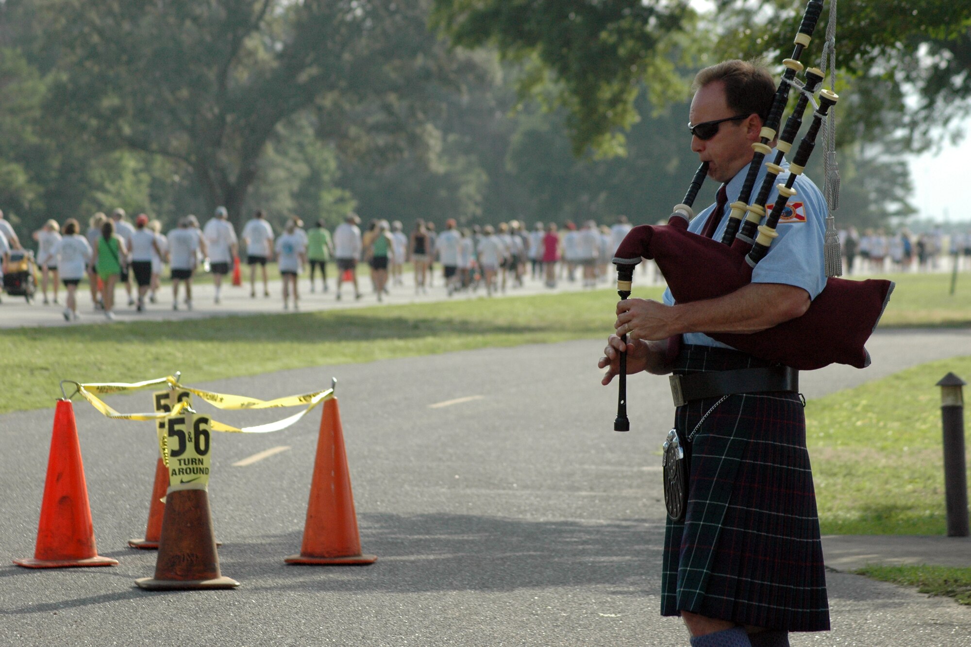 EGLIN AIR FORCE BASE, Fla. – A bagpipe player plays as runners pass the All Wars Memorial May 25, during the 24th Annual Gate-to-Gate Run. The event is an Eglin tradition dating back to 1985, when now retired Lt. Gen. Gordon Fornell, former Armament Division commander here, proposed a run as a way to keep Airmen on base for Memorial Day due to the rise in injuries and fatalities involving Airmen. Traditionally, the run went from gate to gate but was recently modified for safety reasons. More than 1,950 runners participated in the event ranging from ages eight to 87. Matthew Martin, 26, from Hoover, Ala., was the first to finish with a time of 23:34. 2nd Lt. Ilea Eskildsen, 23, was the first female to finish with a time of 27:24. (U.S. Air Force photo/ Airman Anthony Jennings)