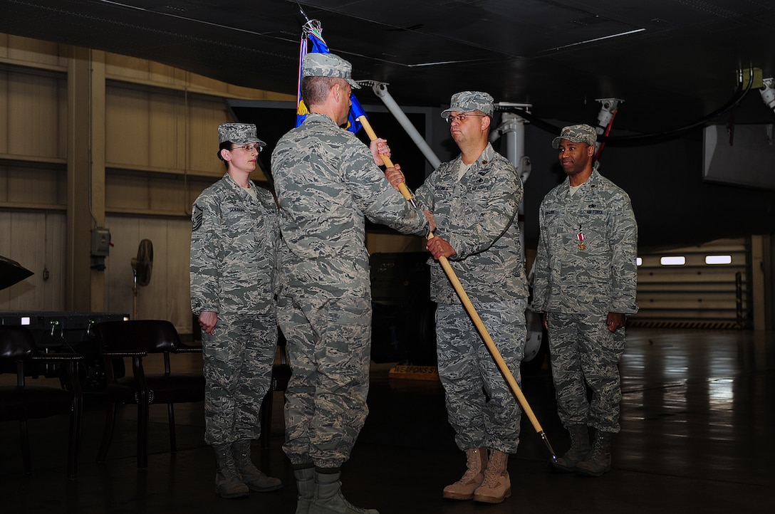 Maj. Steven Haynes, incoming 28th Maintenance Operations Squadron commander, receives the guidon from Col. Thomas Fitch, 28th Maintenance Group commander, during a change of command ceremony here, May 21. By receiving the guidon, Major Haynes assumes command of the 28 MOS. (U.S. Air Force photo/Airman 1st Class Joshua Seybert)