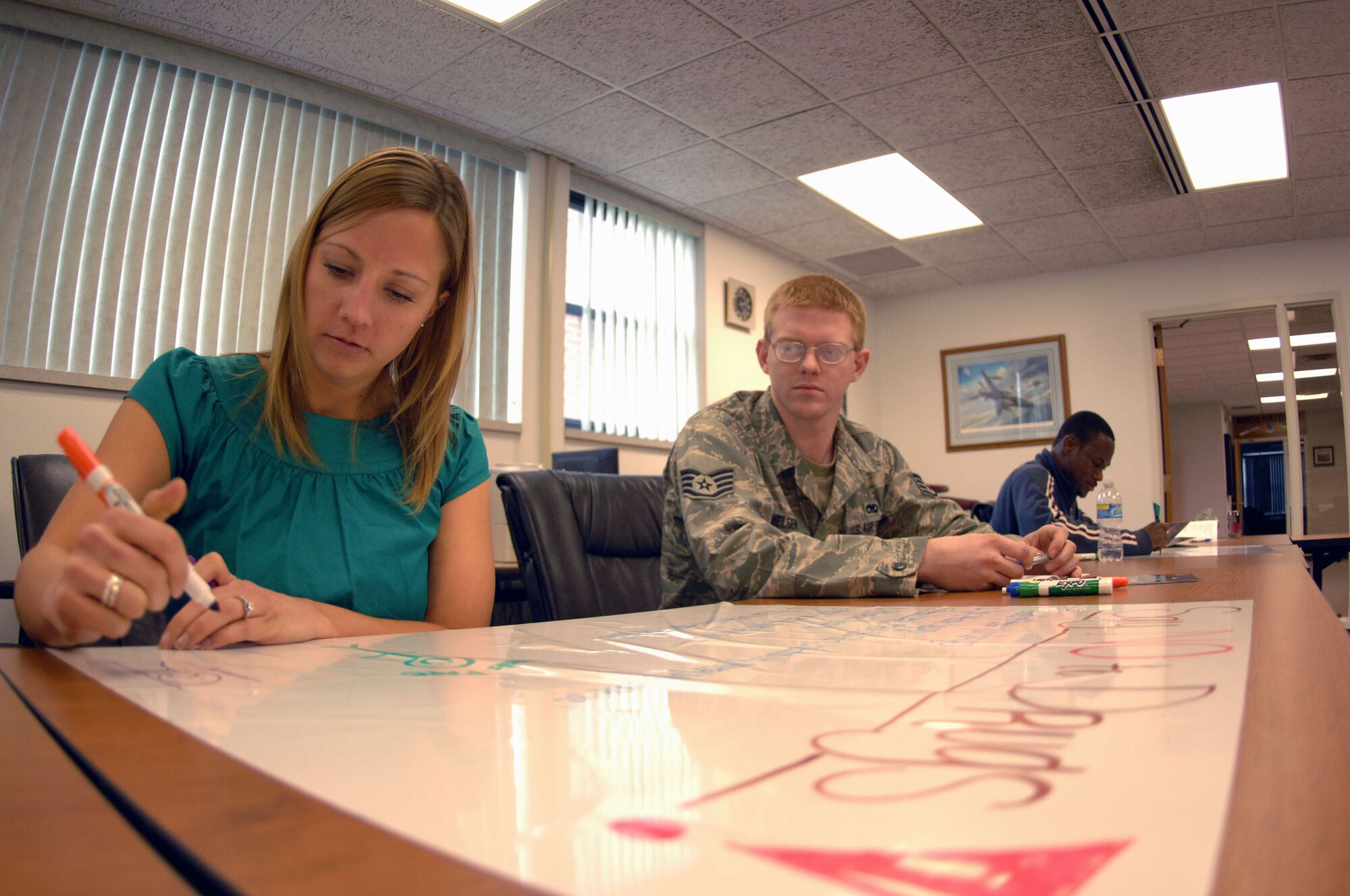 MINOT AIR FORCE BASE, N.D. -- Lisa Hofmann, 5th Force Support Squadron military child education consultant, and Staff Sgt. Benjamin Nielsen, 5th Maintenance Squadron, participate in a personality assessment exercise during the Four Lenses teambuilding workshop here May 20. The workshop was sponsored by the Airman & Family Readiness Center. The goal was to help members understand those around them, gain tips on working together in a professional environment and strengthen personal relationships. (U.S. Air Force photo by Staff Sgt. Angel Gallardo)