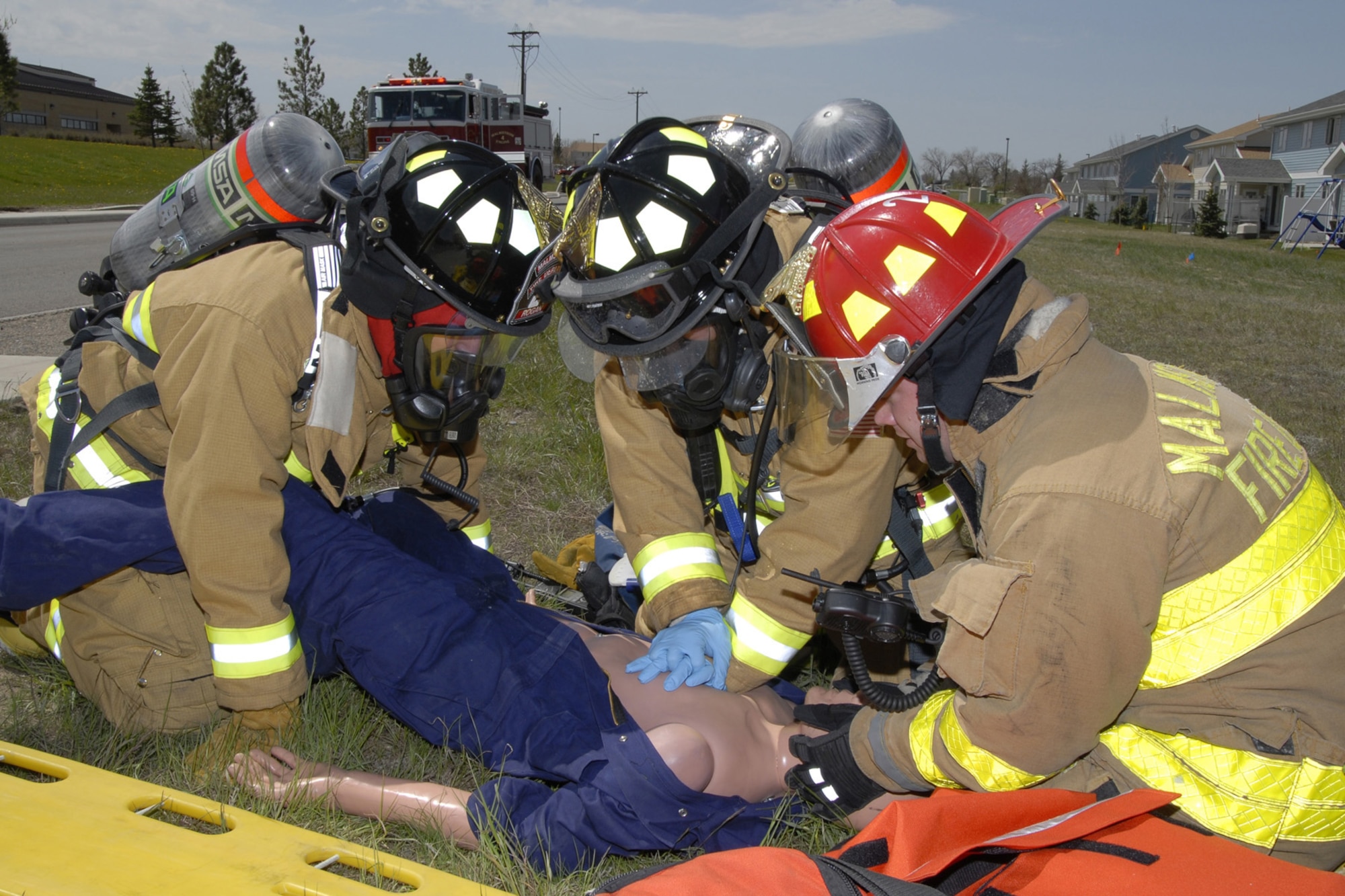 Members of the Malmstrom fire department perform CPR on a motor vehicle accident victim during an exercise scenario May 18. The event was part of a three day local operational readiness exercise. (U.S. Air Force photo/John Turner)